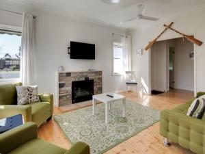 a living room with a couch and a fireplace at Mary Grant in Port Fairy