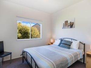 a bedroom with a bed and a window at Julieanne in Port Fairy