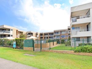 an image of an apartment complex with a fence and grass at Headlands 10 Two Bedroom Beachside Apartment with Magical Ocean Views Great Value for Money in Alexandra Headland