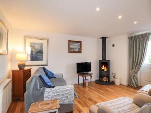 a living room with a couch and a fireplace at Seaview in Nairn