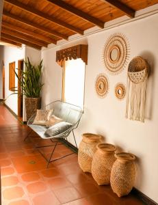 a room with a chair and baskets on the wall at La Casa de Ana in Jardin