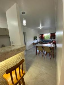 a kitchen and dining room with a table and chairs at APARTAMENTO EM LOCAL PRIVILEGIADO in Maceió