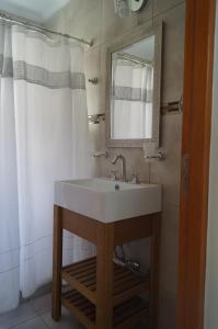 a bathroom with a sink and a mirror at Complejo Los Plumerillos in Chascomús +16 photos