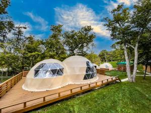 a luxury dome tent on a wooden deck at Muroran Gramping - Golf Resort in Muroran