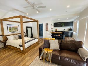 a living room with a couch and a bed at Casa Swift in McLaren Flat