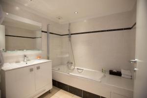 a bathroom with a tub and a sink and a shower at Royal Antibes - Luxury Hotel, Résidence, Beach & Spa in Antibes