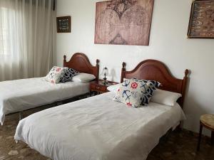 Postel nebo postele na pokoji v ubytování Hogar Pepa