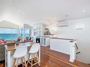 a kitchen and living room with a table and chairs at Farmers Retreat in Port Fairy