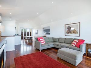 a living room with a couch and a table at Farmers Retreat in Port Fairy
