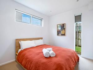 a bedroom with a bed with two towels on it at Farmers Retreat in Port Fairy
