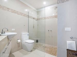 a bathroom with a toilet and a sink and a shower at Farmers Retreat in Port Fairy +13 photos