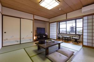 a living room with a couch and a table at Kyoto Higashiyamaso in Kyoto
