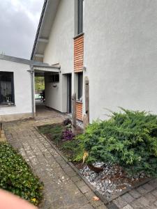 a white house with a garden in front of it at Ferienhaus in Bleicherode in Bleicherode