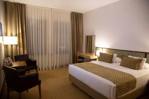 A bed or beds in a room at ATLAS OTELİ