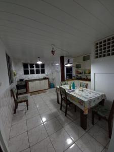 a kitchen with a table and chairs in a room at Caiowa Floripa guesthouse in Florianópolis