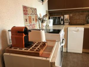 a kitchen with an orange appliance sitting on top of an oven at Appartement Corrençon-en-Vercors, 3 pièces, 6 personnes - FR-1-515-7 in Corrençon-en-Vercors