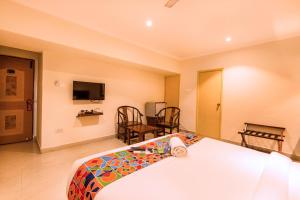 a living room filled with furniture and a table at FabHotel Blossoms Service Apartment in Chennai