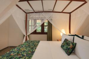 a bedroom with a bed with a canopy at Green Escape Unawatuna in Unawatuna