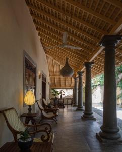 a porch with chairs and a ceiling with a lamp at Green Escape Unawatuna in Unawatuna