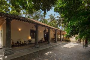 a courtyard of a house with chairs and trees at Green Escape Unawatuna in Unawatuna