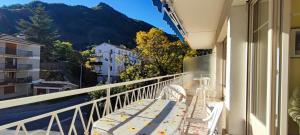 a balcony with chairs and a view of a mountain at Refuge La Pena in Vernet-les-Bains