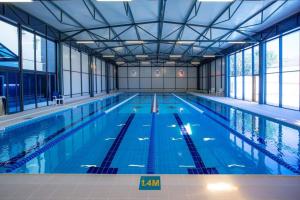 a large indoor swimming pool with a large pool at Georgia Gold in Gori