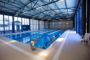 a large indoor swimming pool with a large swimming pool at Georgia Gold in Gori