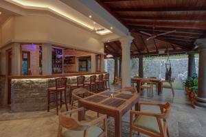 a restaurant with tables and chairs and a bar at Green Escape Unawatuna in Unawatuna