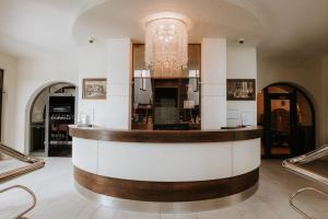 a bar in a restaurant with a chandelier at Hotel Bonaparte in Košice