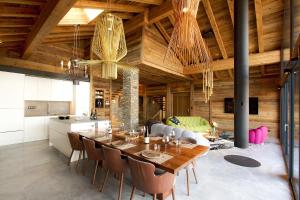 a kitchen and dining room with a table and chairs at Chalet le 1700 in Les Deux Alpes