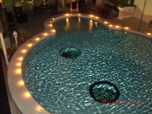 a swimming pool with lights in a backyard at night at Villa Elit in Dugi Rat