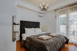 Postel nebo postele na pokoji v ubytování Filippos Acharnes Elegance