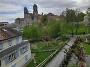 a view of a building with a garden in front of it at Gasthaus Meinradsberg in Einsiedeln +14 photos