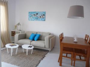 a living room with a couch and a table at Cala Galdana Apartamentos El Rio in Cala Galdana