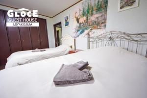 GLOCE PORT SIDE HOUSE l 砂山ビーチ近くのオーシャンビューバルコニーハウスを貸切 長期滞在向け BBQ可客房内的一张或多张床位