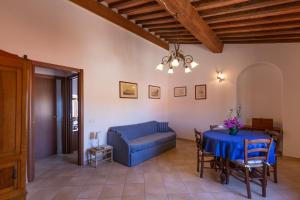 a living room with a blue couch and a table at HelloElba Appartamento Il Faro 2 in Portoferraio