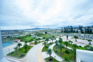 arial view of a street with palm trees and buildings at Navy Hotel Cam Ranh in Cam Ranh