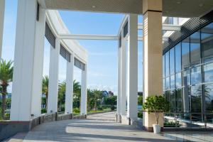 a view of a building with columns and windows at Navy Hotel Cam Ranh in Cam Ranh