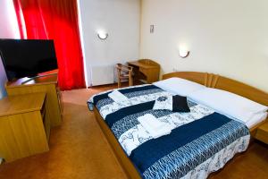 Posteľ alebo postele v izbe v ubytovaní Hotel pod Zámkom