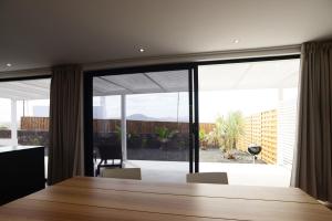 a dining room with a table and a large window at Duna Colorada 6 in Lajares