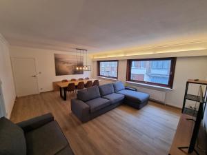 - un salon avec un canapé et une table dans l'établissement Duplex Appartement Opex, à Ostende