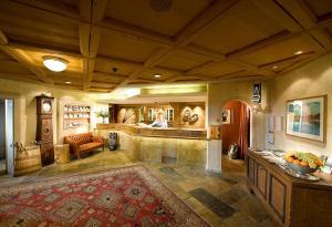 a large living room with a bar in a house at GOLFHOTEL Les Hauts de Gstaad & SPA in Gstaad