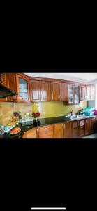 a kitchen with wooden cabinets and a counter top at Airi Villas Ba Vì Venue Travel in Ba Vì