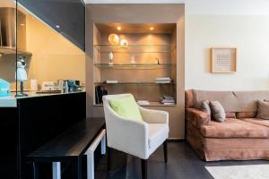 a living room with a couch and a chair at Estoril Charming Apartment in Estoril