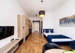 a hotel room with two beds and a tv at Studio Matejki D in Bielsko-Biala
