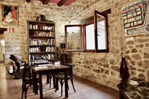 a dining room with a table and a book shelf at Casa rural restaurante Mas Del Rei in Calaceite