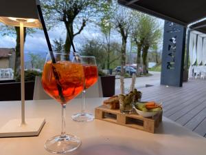 two glasses of wine sitting on a table at Albergo Ristorante Plaza in Tornolo