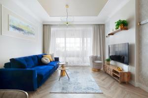 Televízia a/alebo spoločenská miestnosť v ubytovaní Elite Apartments Granaria The View