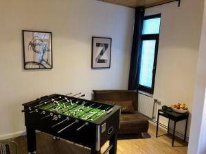 sala de estar con futbolín frente a un sofá en Das blaue Türchen - Wohnung mit Beamer und Kicker, en Bremerhaven
