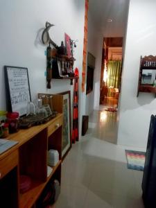 a living room with a table and a hallway at Rec Art (House of recycle+Art) in Ko Samed